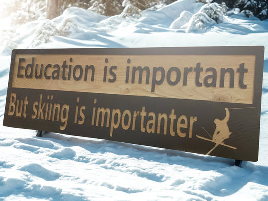 Custom wood ski sign outdoors in snow with 'Education is important but skiing is importanter' text.