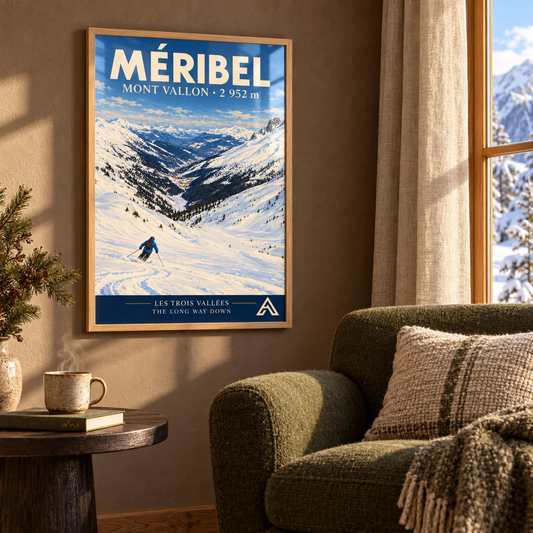 Méribel Mont Vallon art print in Natural Oak beside a moss-green armchair against a warm brown wall, with winter sunlight reflecting across the glazing.