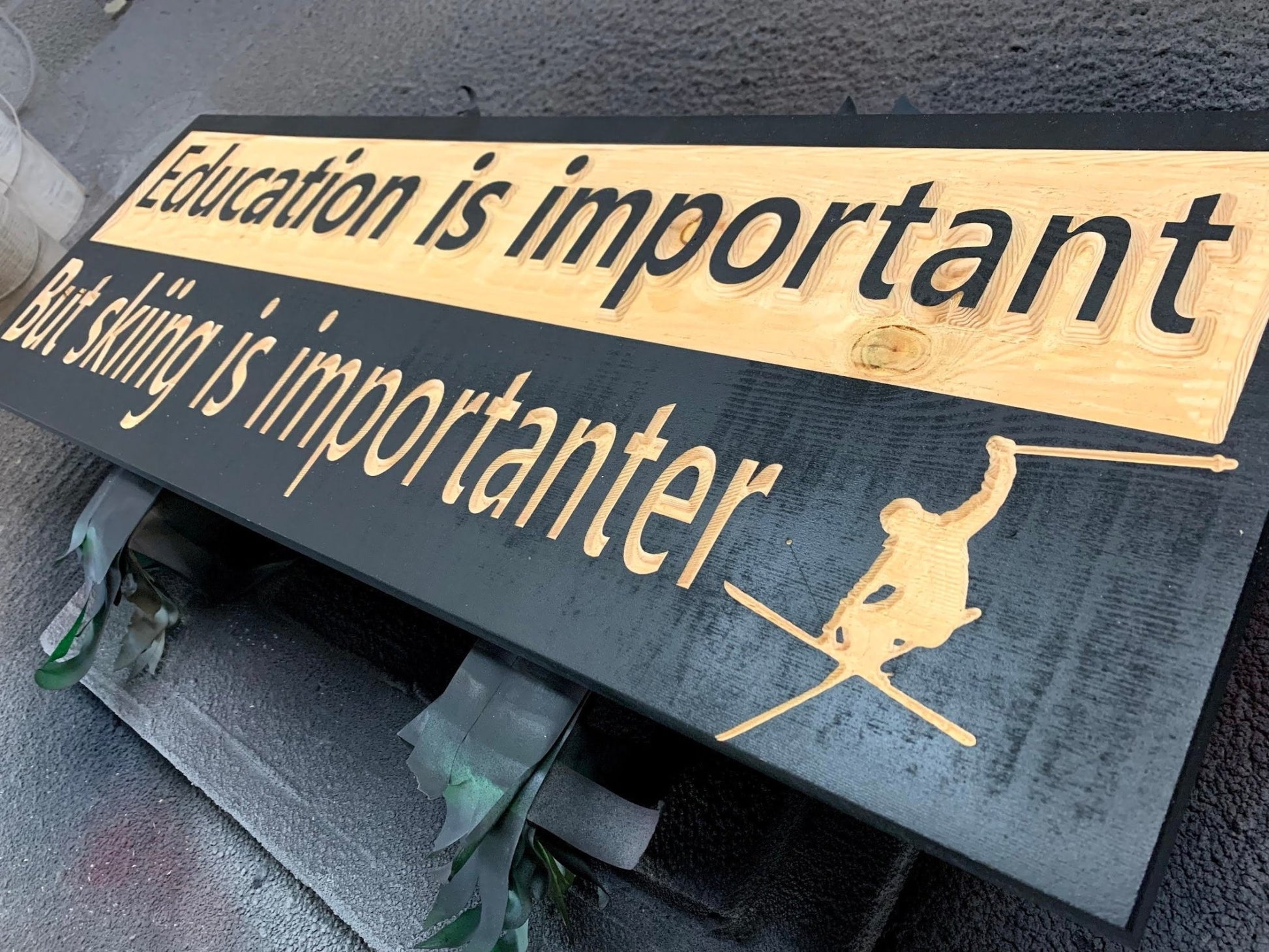 "Education is important but skiing is importanter" sign on solid spruce - Advent Wood Products