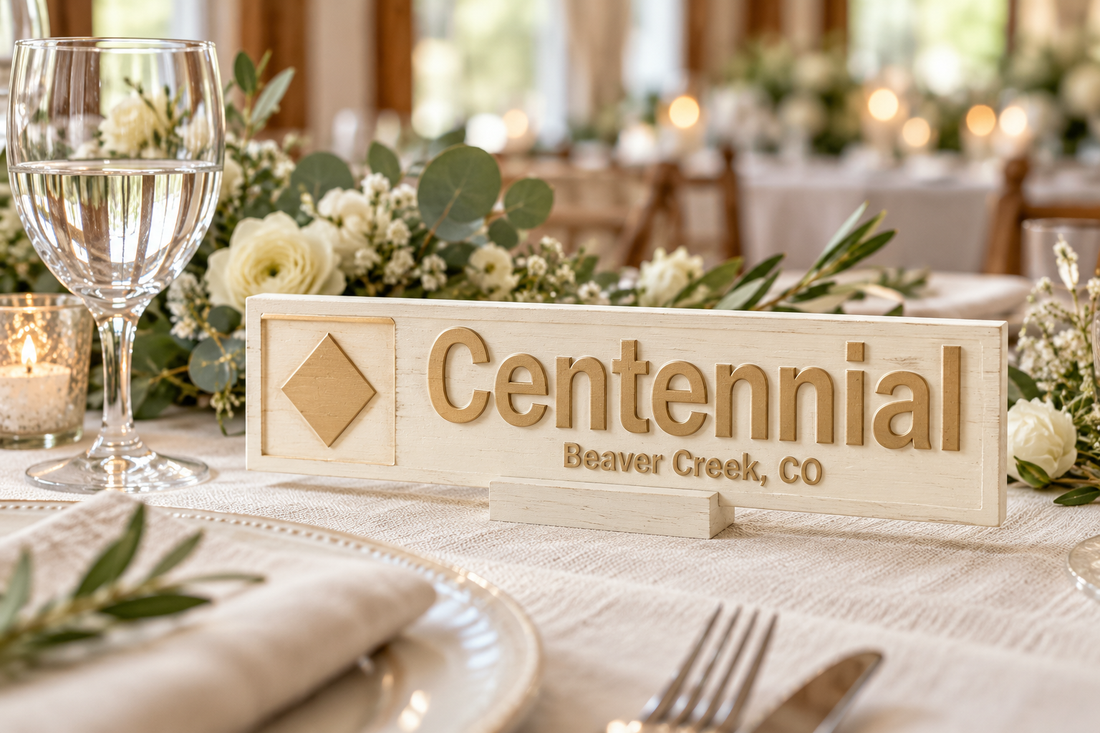 Warm white with gold lettering and accents on a personalised ski wedding table marker; illustrative finish mockup