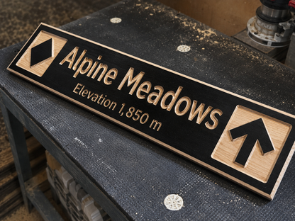 Wooden ski trail sign with 'Alpine Meadows' and elevation details on a workbench.