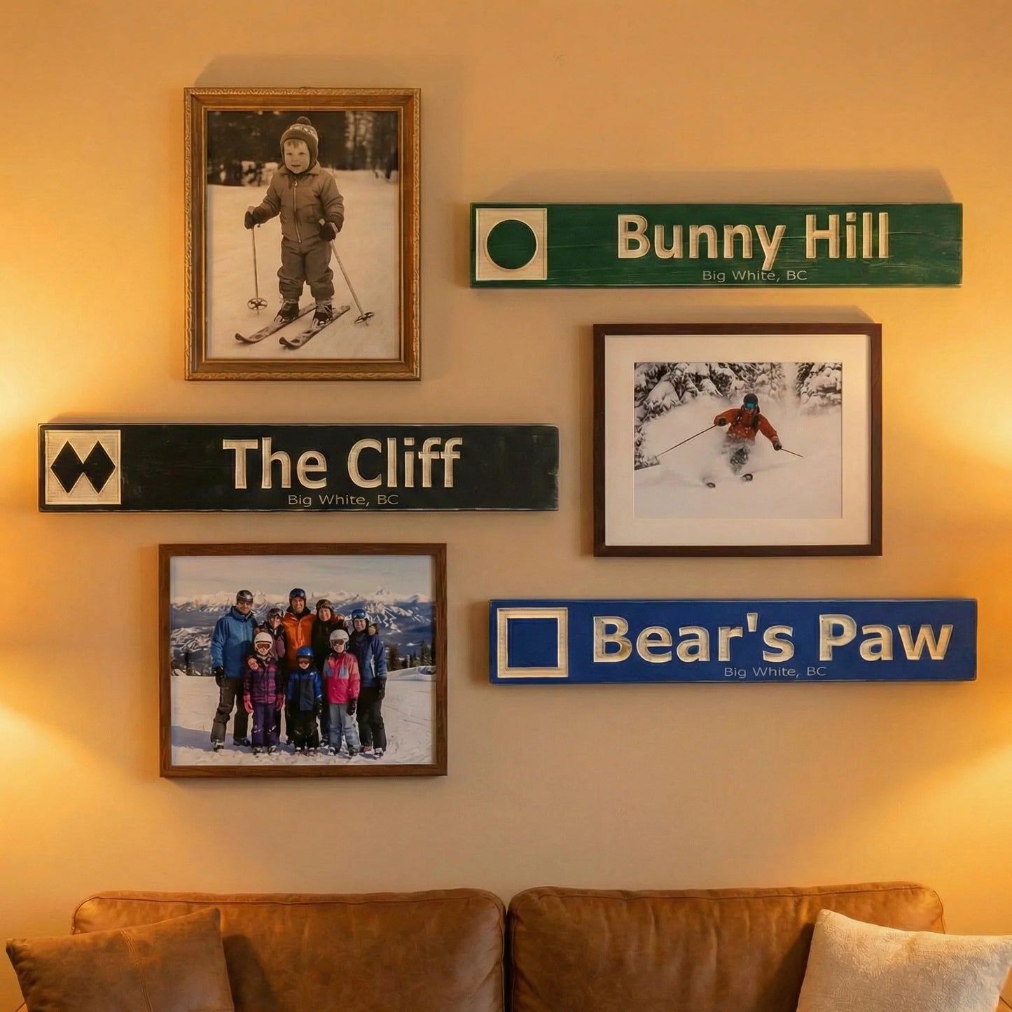 Personalized wooden ski trail signs and framed skiing photos on a cozy living room wall.