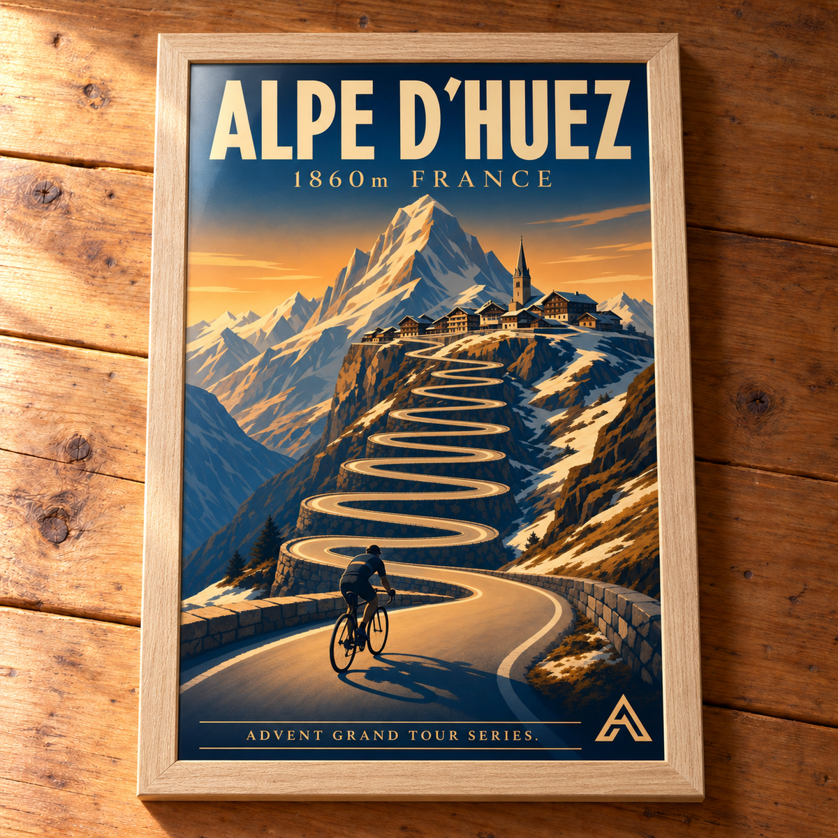 Complete Alpe d’Huez framed cycling art print in Natural Oak on a timber tabletop, showing all four frame edges in natural side light.