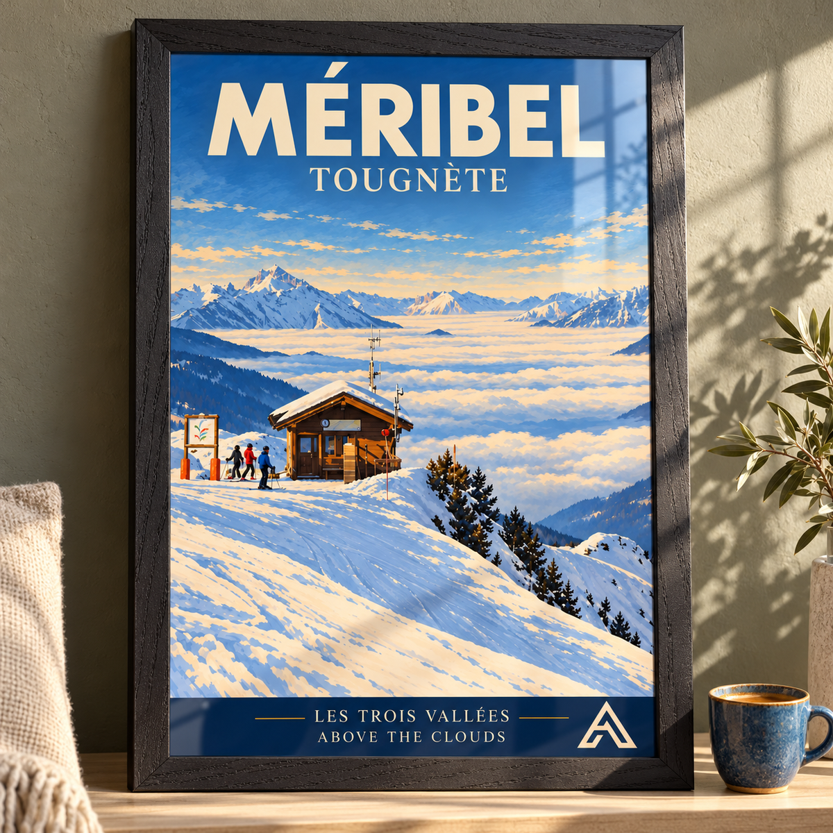 Méribel Tougnète art print in a black ash frame on a sunlit tabletop, showing skiers beside a mountain hut above a sea of clouds.