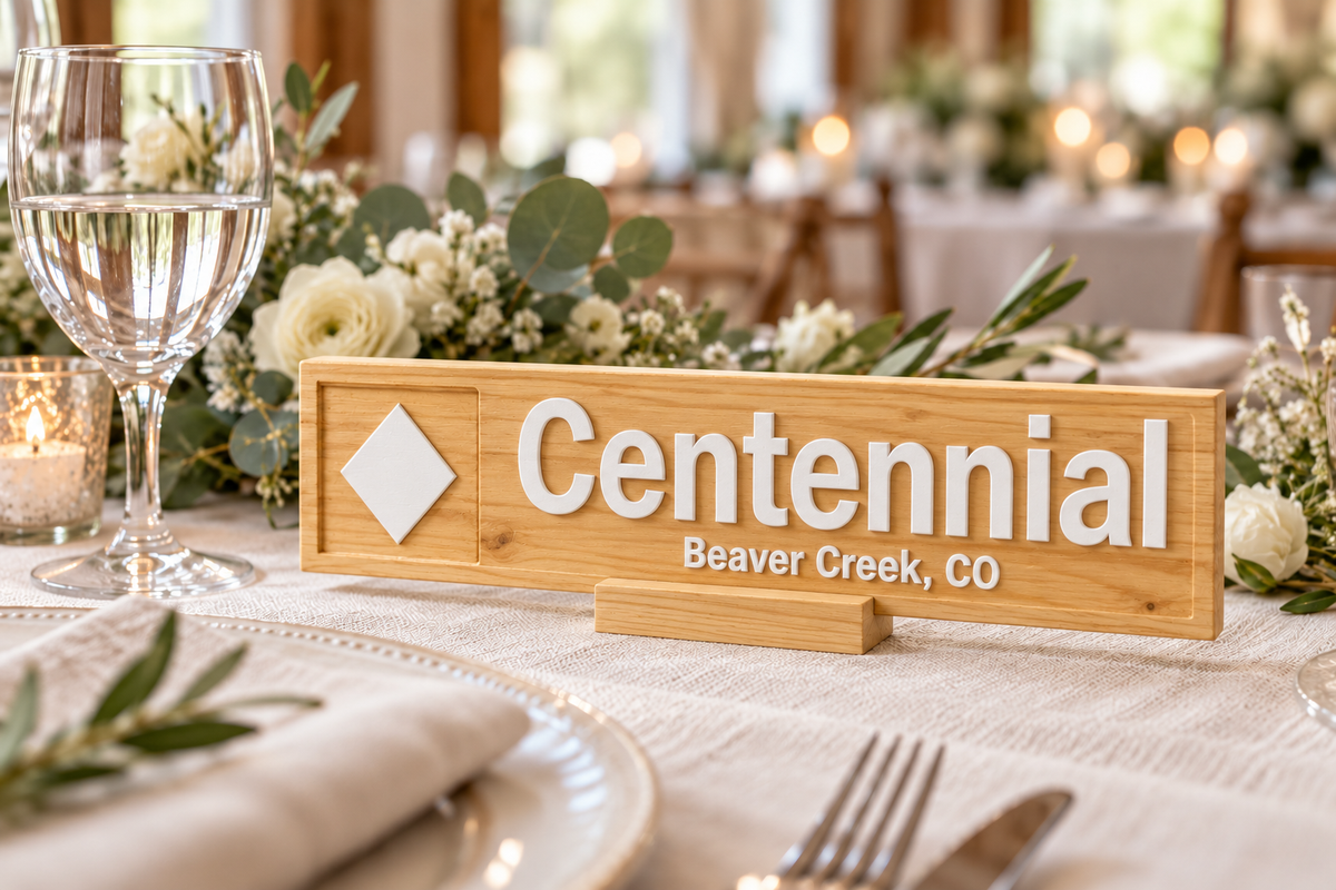 Natural wood with white lettering and accents on a personalised ski wedding table marker; illustrative finish mockup