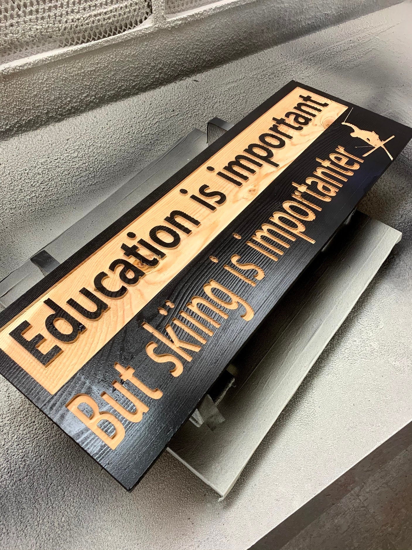 "Education is important but skiing is importanter" sign on solid spruce - Advent Wood Products