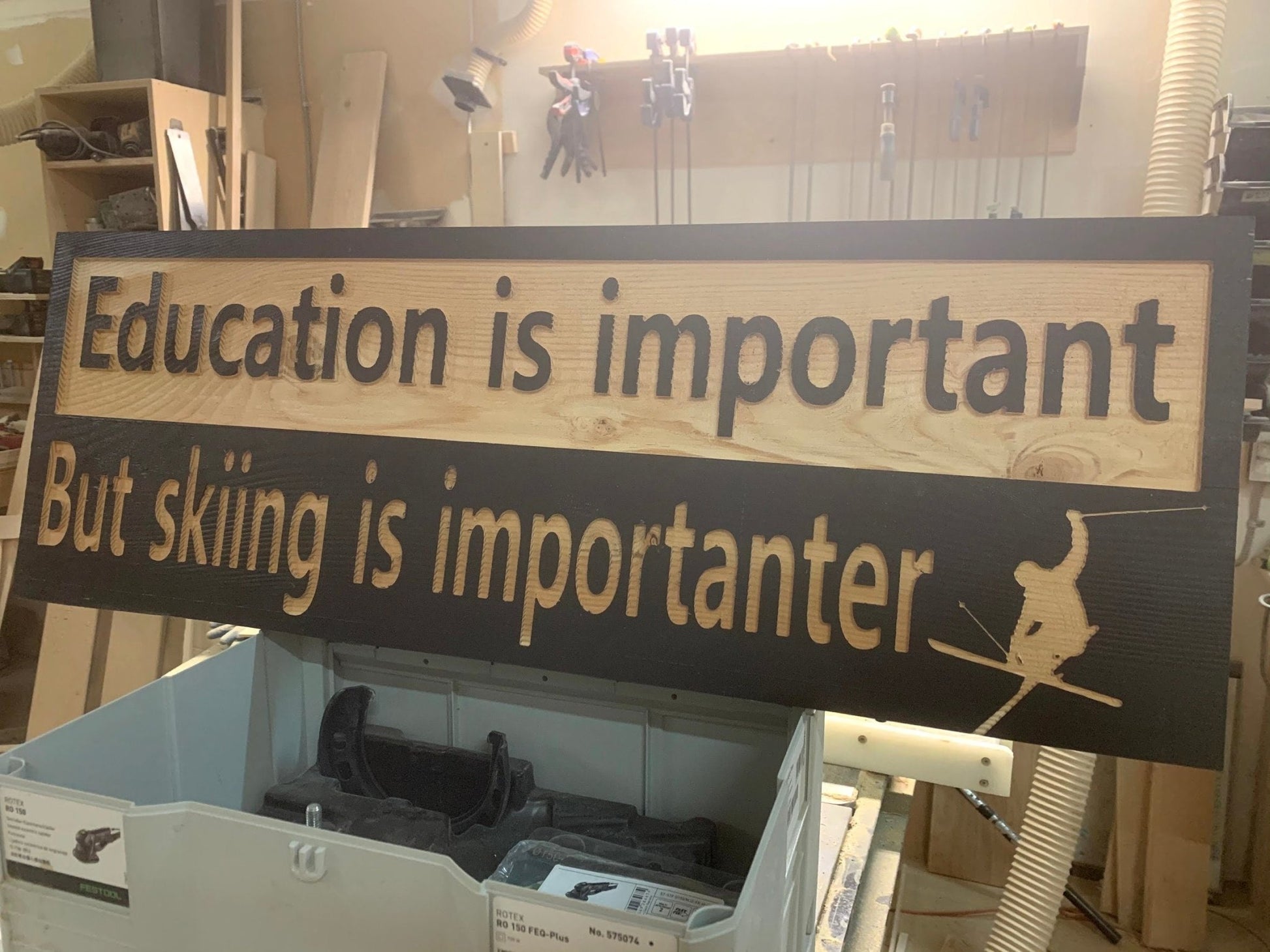 "Education is important but skiing is importanter" sign on solid spruce - Advent Wood Products
